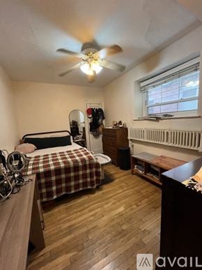 Brookline apartment for rent - A bedroom with a bed, a dresser, and a window.