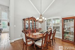 Lewisville house for rent - A dining room with a wooden table and chairs.