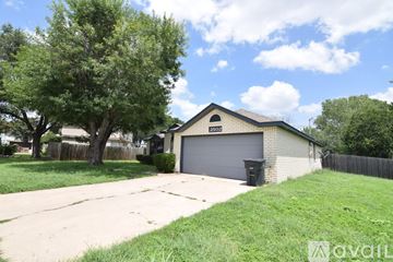 Killeen house for rent - A kitchen with wooden cabinets and black appliances.