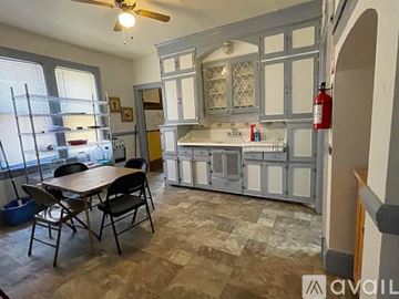 Milwaukee apartment for rent - A kitchen with a table and chairs in front of a window.