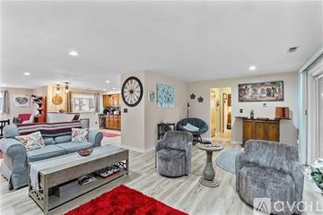Dayton house for rent - A living room with a grey sofa, a grey armchair, a grey chair and a grey coffee table.