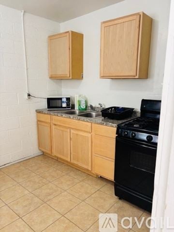 El Paso apartment for rent - A kitchen with wooden cabinets and black appliances.