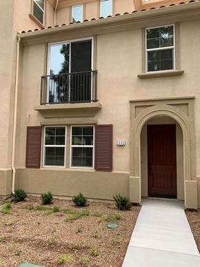 Camarillo apartment for rent - A tan building with a balcony and a brown door.