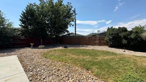 Aurora apartment for rent - A backyard with a gravel area and a wooden fence.