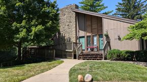 Kansas City apartment for rent - Entrance to a clubhouse building with a sidewalk leading up to it