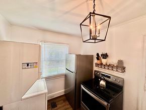 Columbia house for rent - A kitchen with a stove top oven and a refrigerator.