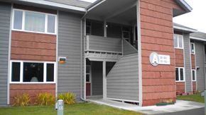 Kenai apartment for rent - A building with a red brick facade and a grey roof.