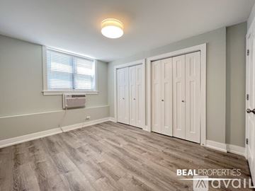 Chicago condo for rent - A kitchen with black cabinets and a refrigerator.
