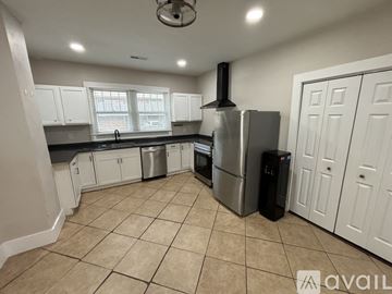 Florence house for rent - A kitchen with a stainless steel refrigerator and a black trash can.