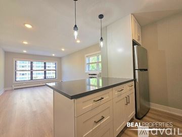 Chicago condo for rent - A kitchen with a stove top oven and microwave above it.