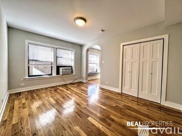 Chicago condo for rent - A kitchen with wooden cabinets and a washing machine.