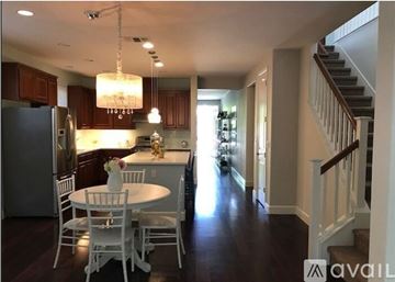 Chico house for rent - A kitchen with a table and chairs and a staircase.