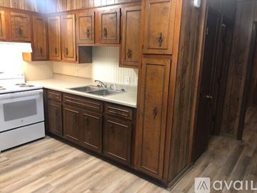 Church Hill apartment for rent - A kitchen with wooden cabinets and a white stove.