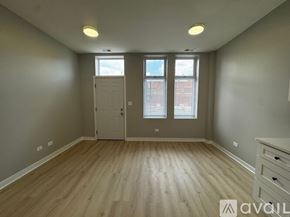 Chicago apartment for rent - A room with wooden flooring and a white door.