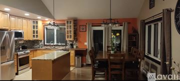 Florida house for rent - A kitchen with wooden cabinets and a granite countertop.