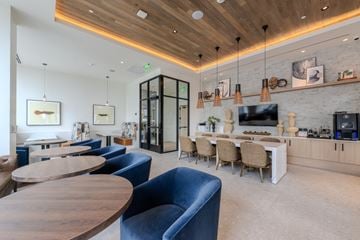 Ft Lauderdale apartment for rent - A modern living room with a blue sofa and a wooden table.