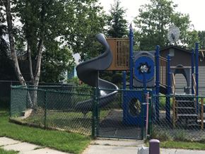 Kenai apartment for rent - A playground with a blue and yellow slide.