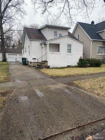 Hazel Park house for rent - A white house with a grey roof and a green trash can in front of it.
