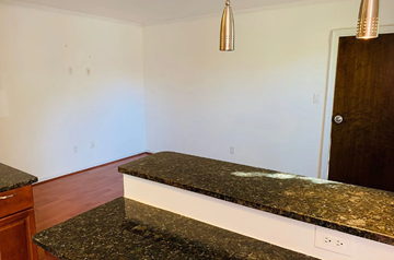 Washington apartment for rent - A kitchen counter with a granite top and white base.