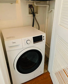 Washington apartment for rent - A white washing machine and dryer in a small laundry room.