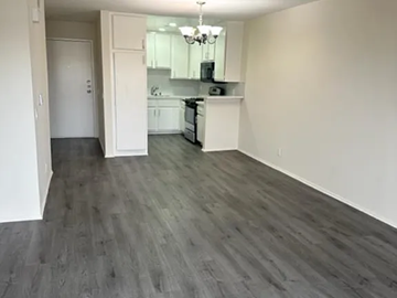 Los Angeles apartment for rent - A kitchen with a white counter and a white fridge.