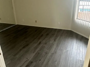 Los Angeles apartment for rent - A room with a wooden floor and a window.
