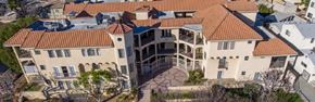 Glendale apartment for rent - A large house with a red tile roof and a circular driveway.