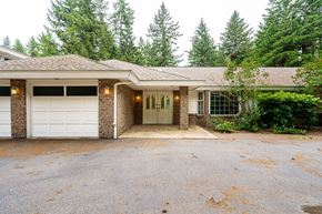 Langley apartment for rent - A house with a brown roof and a white garage door.