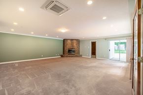 Langley apartment for rent - A spacious living room with a fireplace and a sliding glass door.