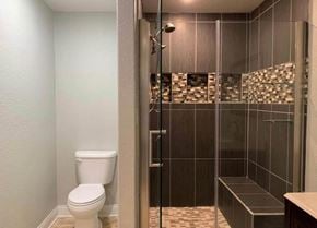 Bay City house for rent - A bathroom with a toilet and a walk in shower.