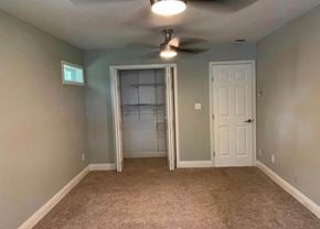 Bay City house for rent - A room with a ceiling fan and a door with a glass panel.