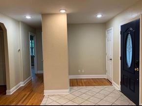 Bay City house for rent - A hallway with a black door and a white door on the other side.