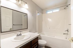 Langley apartment for rent - A white bathroom with a sink, toilet, and bathtub.