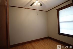 Chicago apartment for rent - A room with a window and a fan on the ceiling.