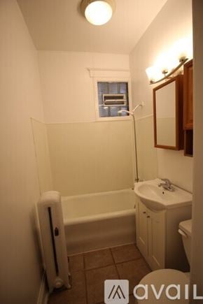 Chicago apartment for rent - A small bathroom with a white tub and sink.