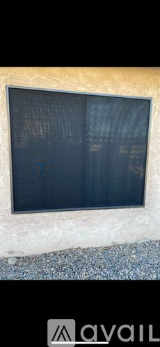 Lake Havasu City apartment for rent - A room with wooden flooring and a window with blinds.