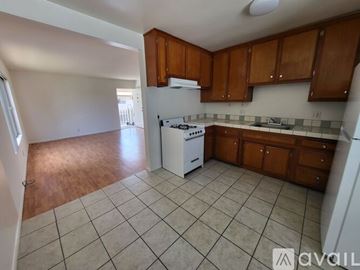 Long Beach apartment for rent - A kitchen with brown cabinets and a white dishwasher.