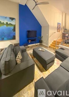 Richmond apartment for rent - A living room with a blue wall and a television.