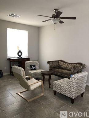 Laughlin townhouse for rent - A living room with a sofa, chair, and table.