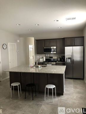 Laughlin townhouse for rent - A kitchen with a granite countertop and a refrigerator.