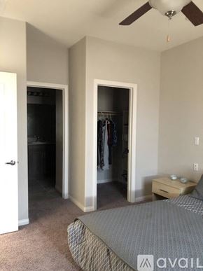 Laughlin townhouse for rent - A bedroom with a bed, dresser, and closet.