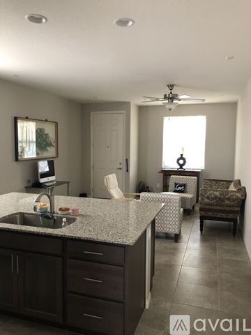 Laughlin townhouse for rent - A kitchen with a sink and a fan on the ceiling.