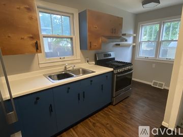 Minneapolis house for rent - A kitchen with blue cabinets and a white countertop.