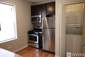Chicago apartment for rent - A kitchen with stainless steel appliances and wooden cabinets.