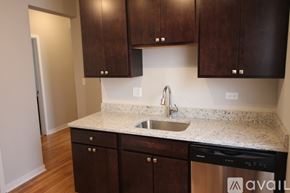 Chicago apartment for rent - A kitchen with brown cabinets and a white sink.