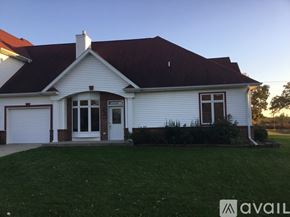 Mc Farland apartment for rent - A white house with a brown roof and a garage door.