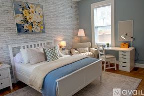 Lafayette apartment for rent - A bedroom with a bed, two doors, and a window.