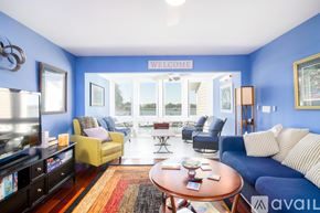 Folly Beach condo for rent - A living room with a blue wall and a sign that says "Welcome".