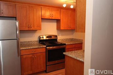 Seattle apartment for rent - A kitchen with wooden cabinets and a stainless steel refrigerator.
