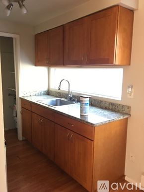 Seattle apartment for rent - A kitchen with wooden cabinets and a marble countertop.